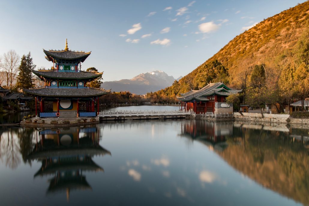 mountain scenary with water and a temple in the background